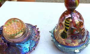 Bismuth paperweight and bud vase.